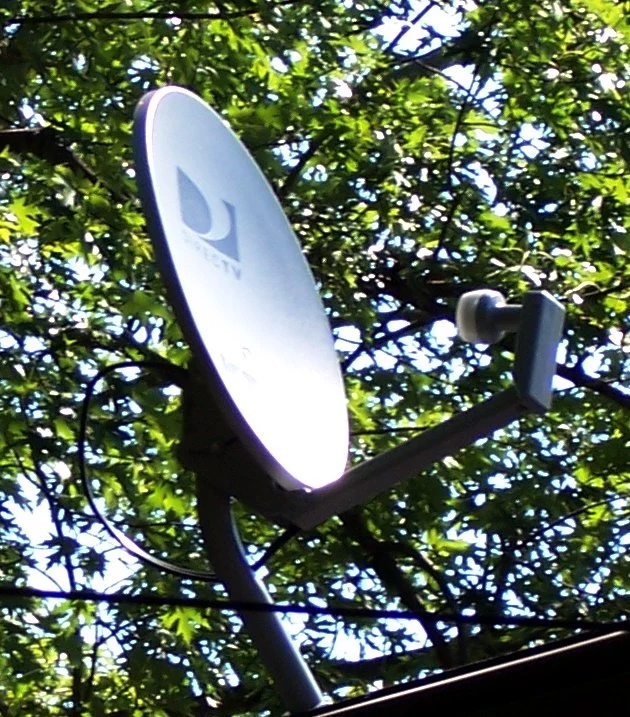 Representative DIRECTV satellite dish mounted on a house roof